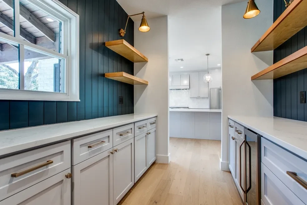 Butler's pantry with dark shiplap wall and floating wood shelves