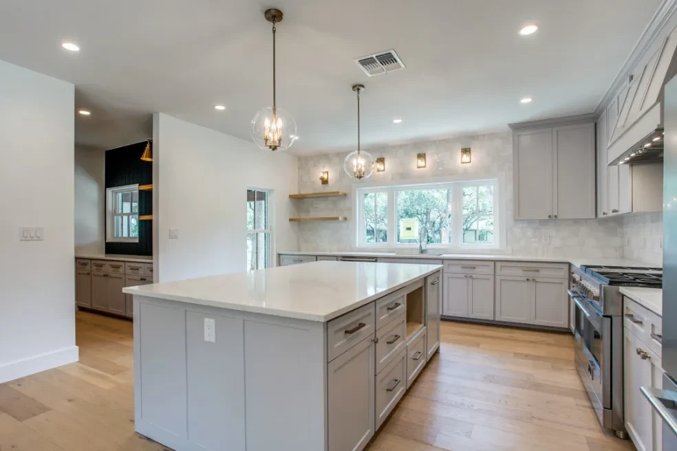 Kitchen from alternate angle showing range and open shelving